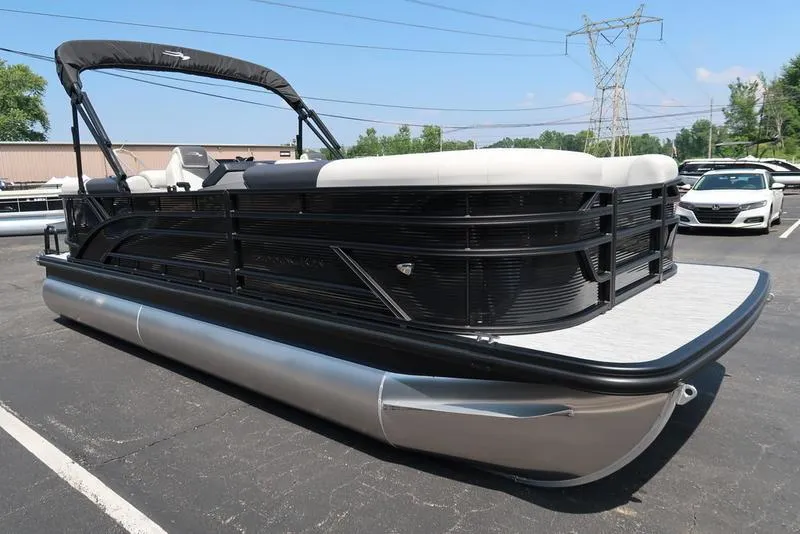 Slide: The Image of 2026 Bennington S Quad Bench 22 SSR pontoon boat in parking lot, black and silver design. - 8