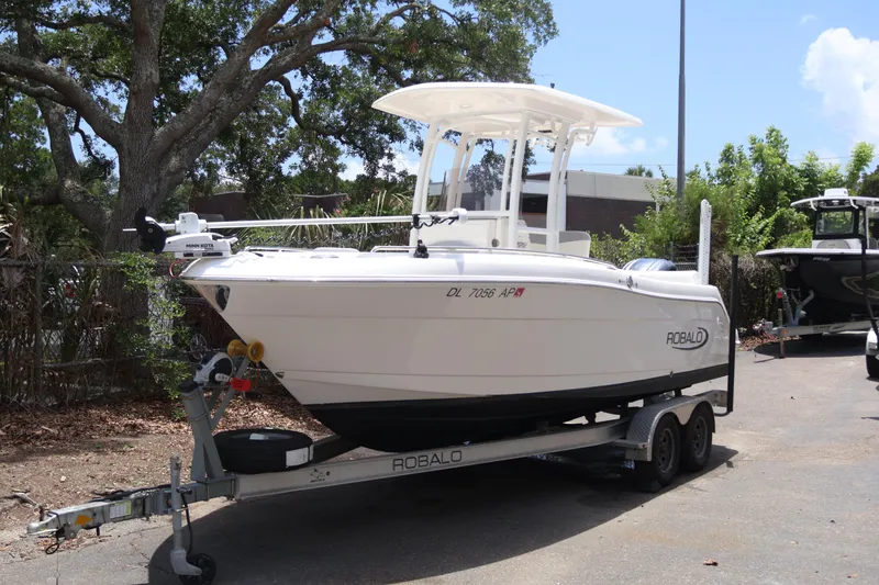 Slide: The Image of 2022 Robalo R222 Center Console boat on trailer, parked outdoors. - 0