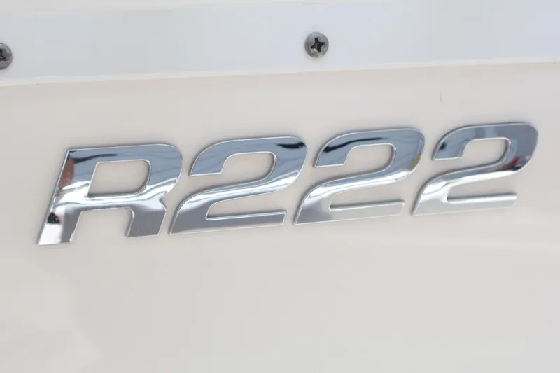 Slide: The Image of Chrome "R222" emblem on 2022 Robalo R222 Center Console boat. - 16