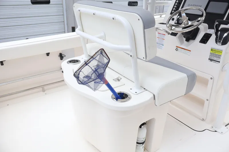 Slide: The Image of 2022 Robalo R222 Center Console interior with fishing net and steering console. - 17