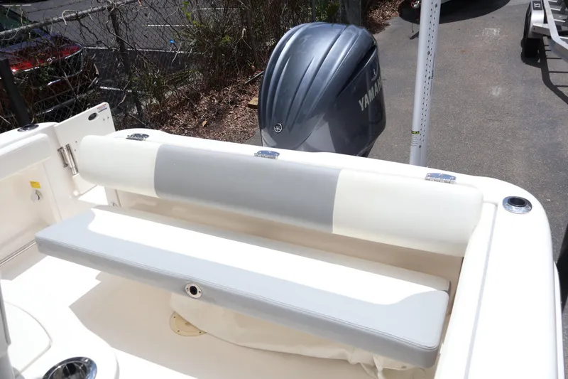 Slide: The Image of 2022 Robalo R222 Center Console boat with Yamaha engine, featuring rear seating and cup holders. - 19