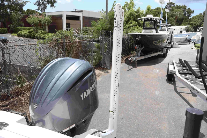 Slide: The Image of 2022 Robalo R222 Center Console boat with Yamaha engine in a marina setting. - 20