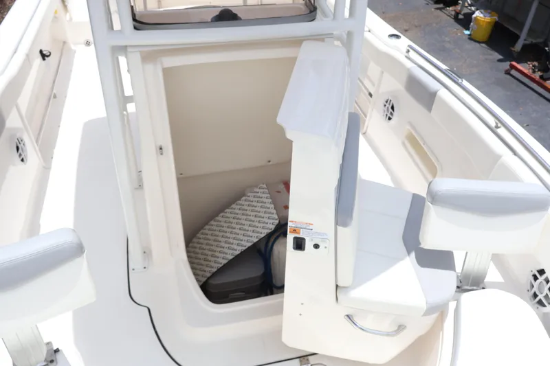 Slide: The Image of 2022 Robalo R222 Center Console boat interior with open storage compartment and seating. - 8