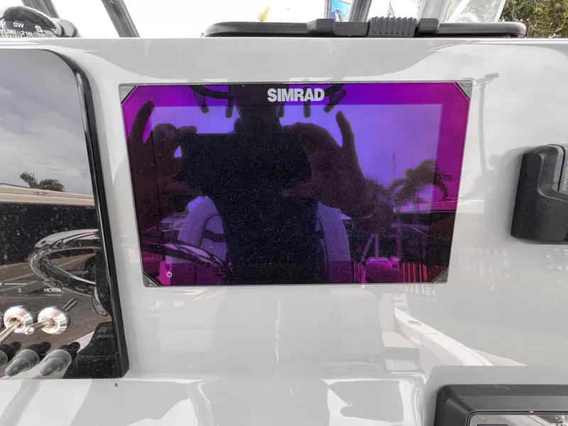 Slide: The Image of Simrad display on 2026 Sea Pro 230 DLX boat dashboard. - 16