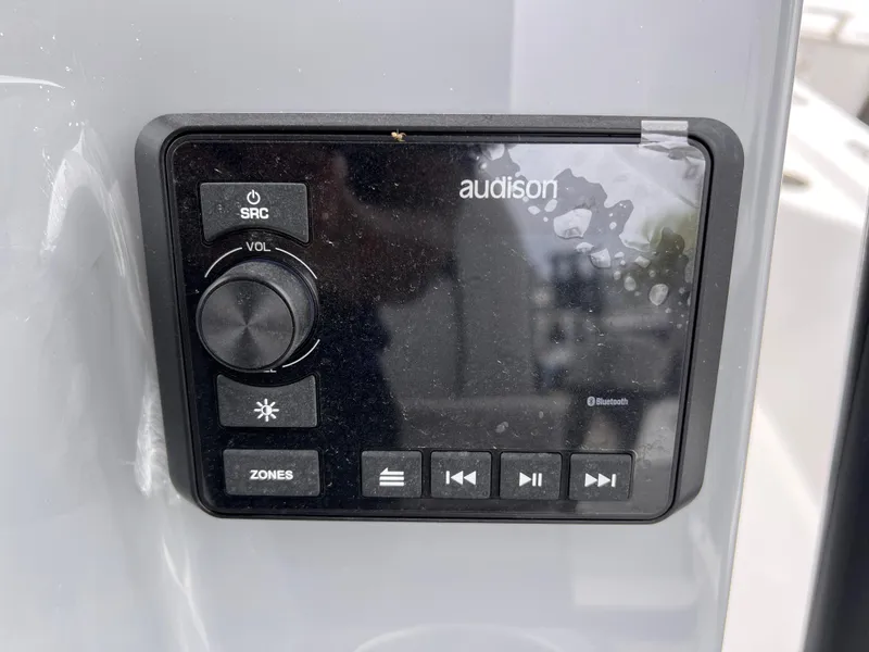 Slide: The Image of Audison audio control panel on 2026 Sea Pro 230 DLX boat, featuring Bluetooth connectivity. - 18