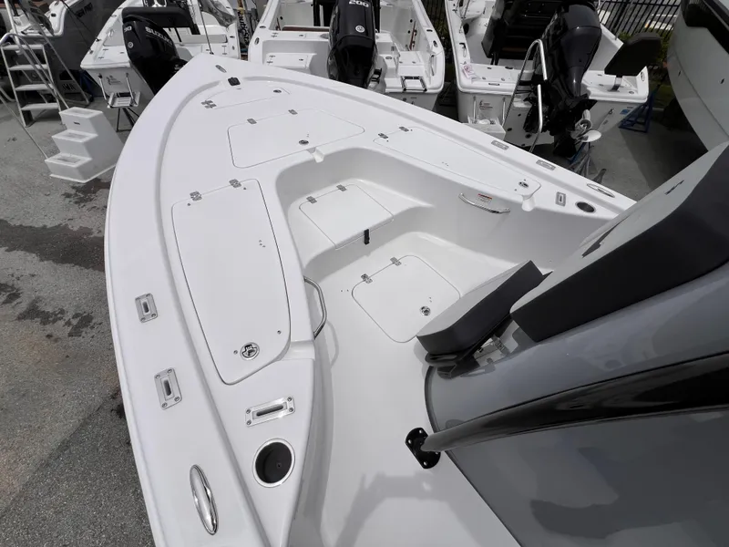 Slide: The Image of 2026 Sea Pro 230 DLX boat interior with seating and storage compartments. - 26