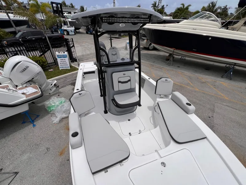Slide: The Image of 2026 Sea Pro 230 DLX boat with sleek seating and modern design in a marina setting. - 32