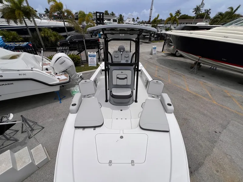 Slide: The Image of 2026 Sea Pro 230 DLX boat with seating, docked in a marina. - 34