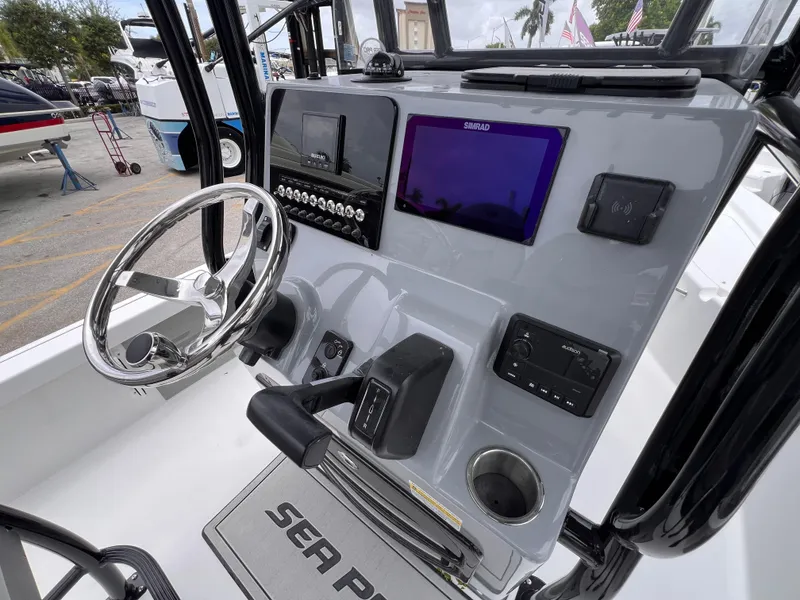 Slide: The Image of 2026 Sea Pro 230 DLX boat dashboard with steering wheel and navigation display. - 35