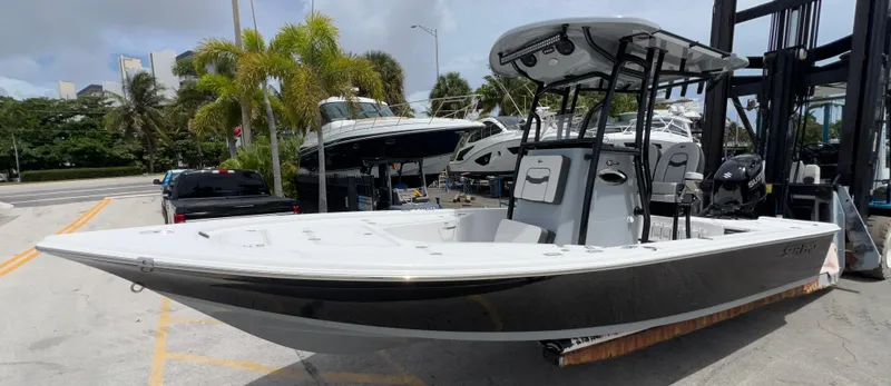 Slide: The Image of 2026 Sea Pro 230 DLX boat displayed at a marina with palm trees. - 39