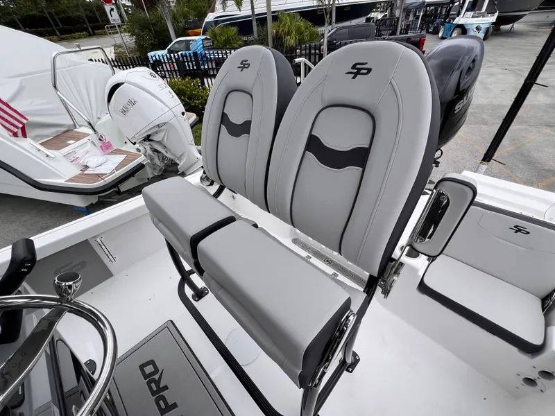 Slide: The Image of 2026 Sea Pro 230 DLX boat interior with gray seating and steering wheel. - 45