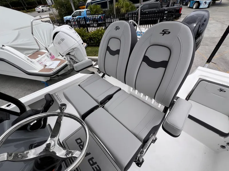 Slide: The Image of 2026 Sea Pro 230 DLX boat interior with dual gray seats and steering wheel. - 46