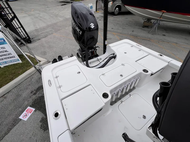 Slide: The Image of 2026 Sea Pro 230 DLX boat with Suzuki outboard motor, featuring spacious deck and storage compartments. - 5