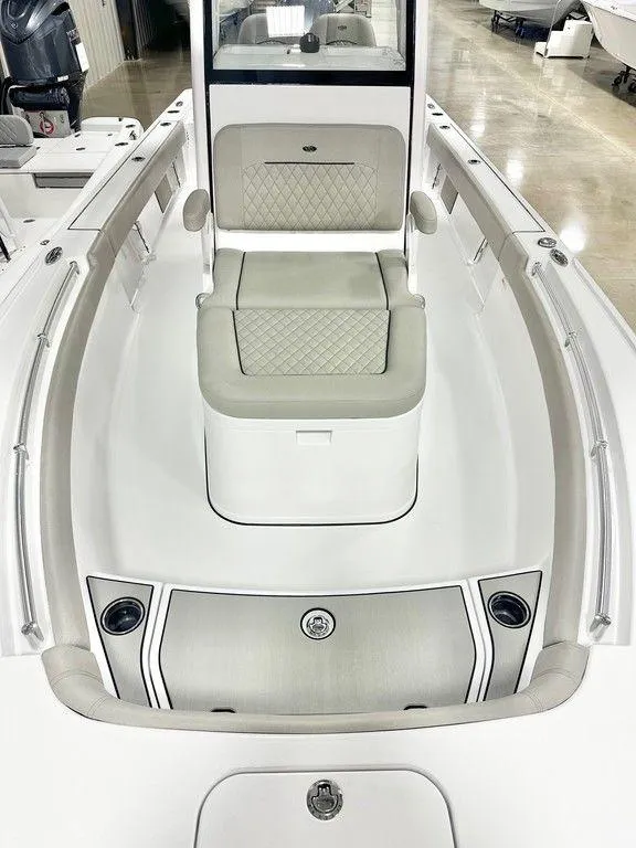 Slide: The Image of 2025 Sportsman MASTERS 247OE boat interior with cushioned seating and sleek design. - 10