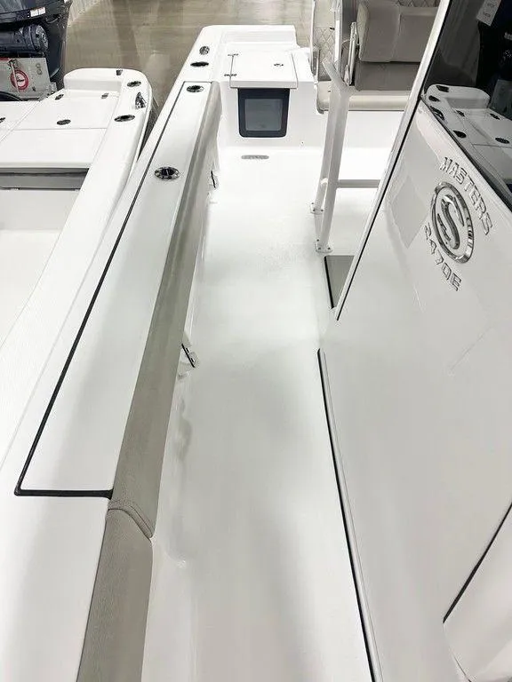 Slide: The Image of 2025 Sportsman MASTERS 247OE boat interior, featuring sleek white design and seating area. - 8