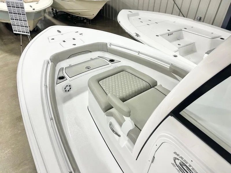 Slide: The Image of 2025 Sportsman MASTERS 247OE boat interior with cushioned seating and storage compartments. - 9