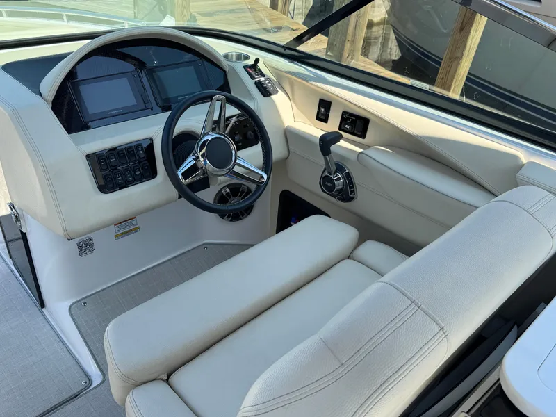 Slide: The Image of 2021 Regal 2800 boat helm with modern controls and steering wheel. - 10