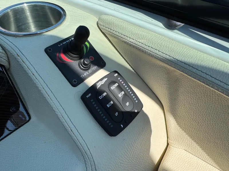 Slide: The Image of Control panel of a 2021 Regal 2800 boat with joystick and trim tab switches. - 19