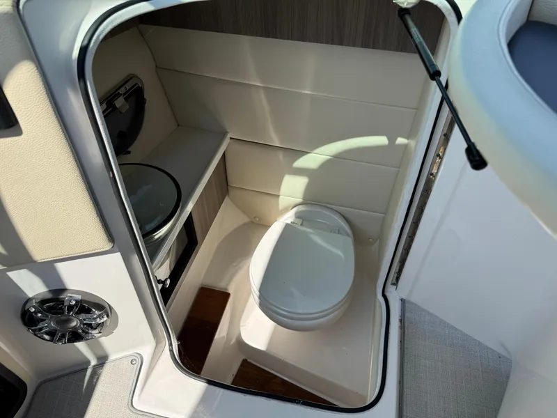 Slide: The Image of 2021 Regal 2800 boat interior bathroom with toilet and sink. - 21