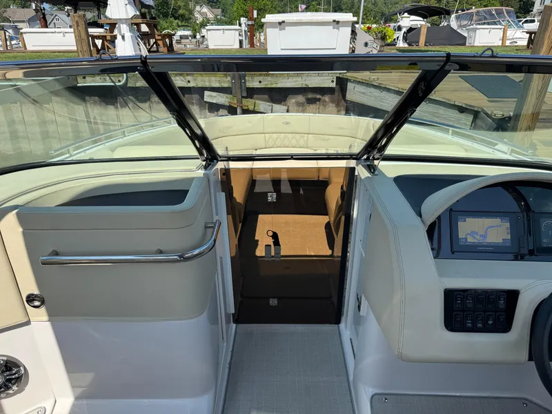 Slide: The Image of 2021 Regal 2800 boat interior with navigation system and seating area. - 23