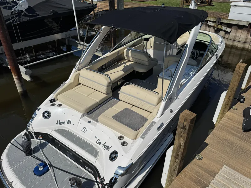 Slide: The Image of 2021 Regal 2800 boat docked, featuring spacious seating and sleek design. - 5