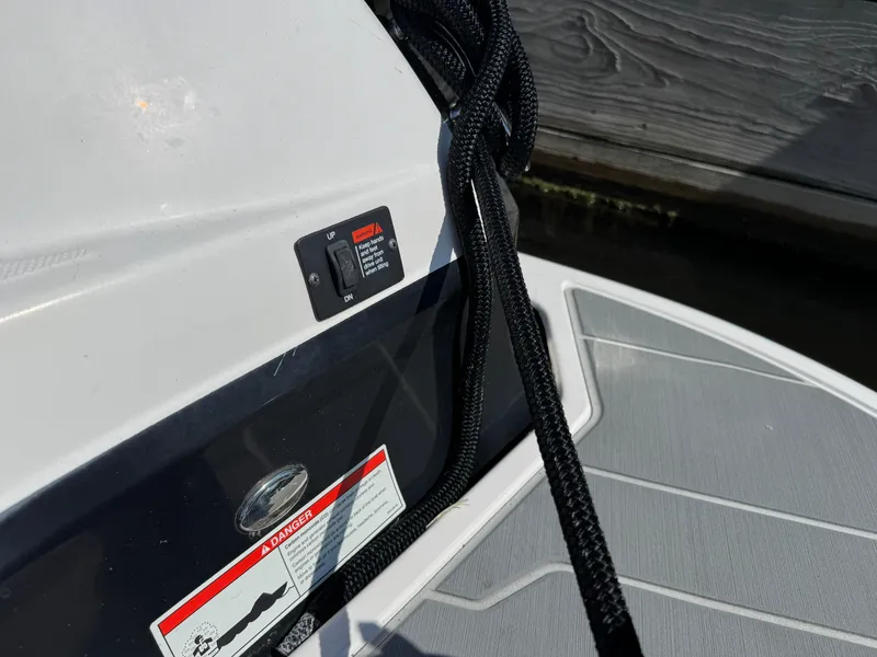 Slide: The Image of 2021 Regal 2800 boat deck with control switch and safety warning label. - 6