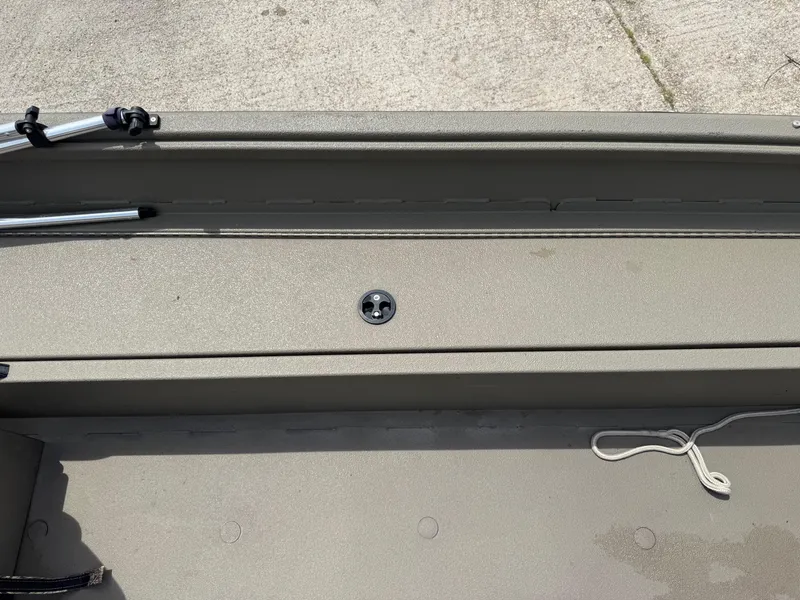 Slide: The Image of 2021 Alumacraft 2072 SC boat interior with rod holders and rope on deck. - 11