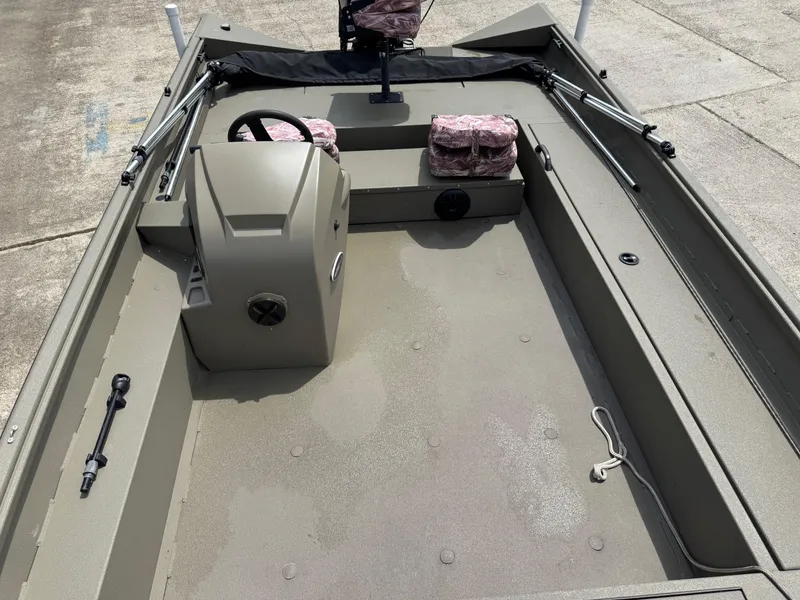 Slide: The Image of 2021 Alumacraft 2072 SC boat interior with steering console and seating. - 7