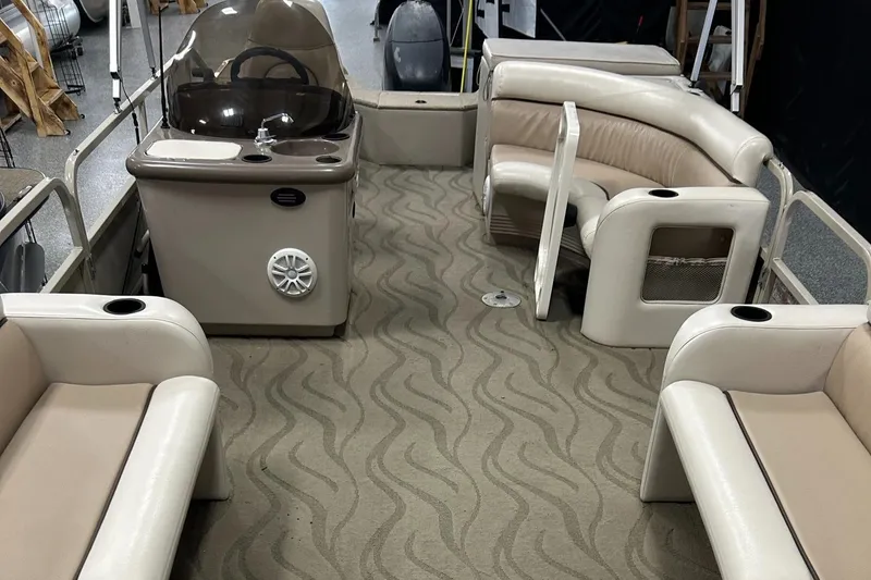 Slide: The Image of 2003 Crestliner LSi Angler 2485 boat interior with beige seating and helm station. - 10