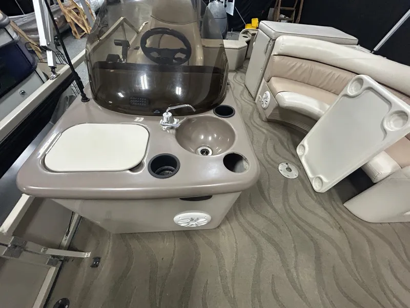 Slide: The Image of 2003 Crestliner LSi Angler 2485 boat interior with steering console, sink, and seating area. - 11