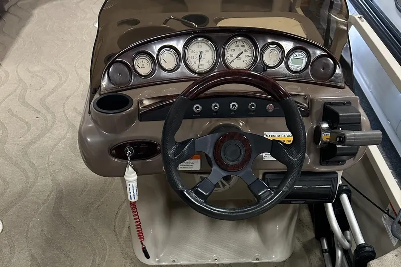 Slide: The Image of 2003 Crestliner LSi Angler 2485 dashboard with steering wheel and instrument panel. - 12