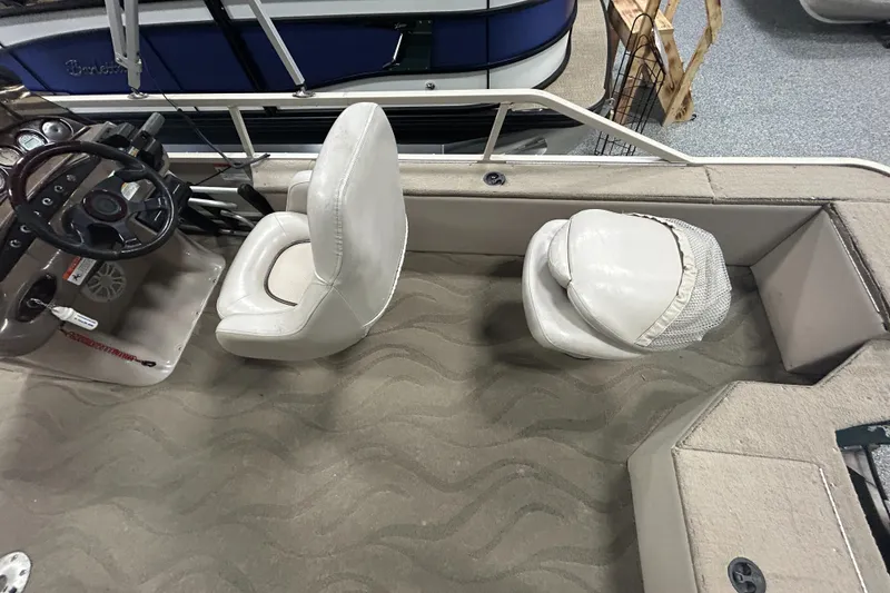 Slide: The Image of 2003 Crestliner LSi Angler 2485 boat interior with steering wheel and seating. - 14