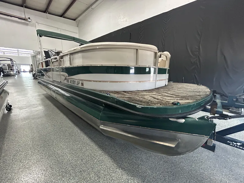 Slide: The Image of 2003 Crestliner LSi Angler 2485 pontoon boat in indoor storage facility. - 5