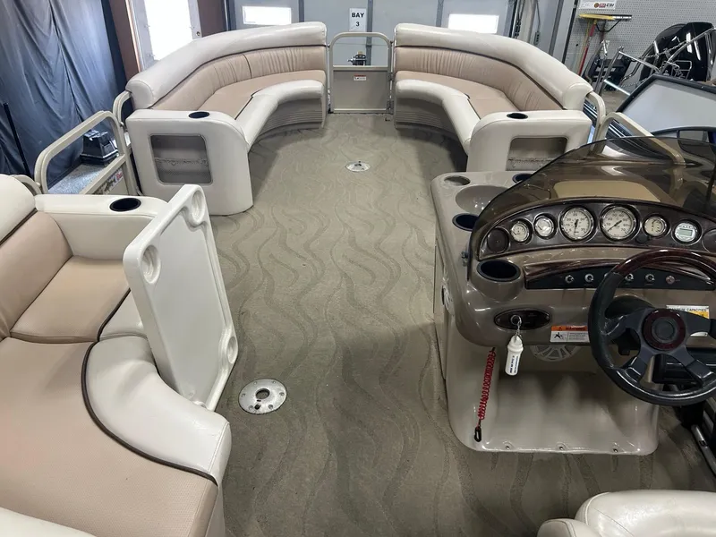 Slide: The Image of 2003 Crestliner LSi Angler 2485 boat interior with beige seating and control panel. - 8