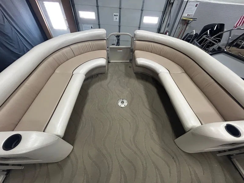 Slide: The Image of 2003 Crestliner LSi Angler 2485 boat interior with beige seating and cup holders. - 9