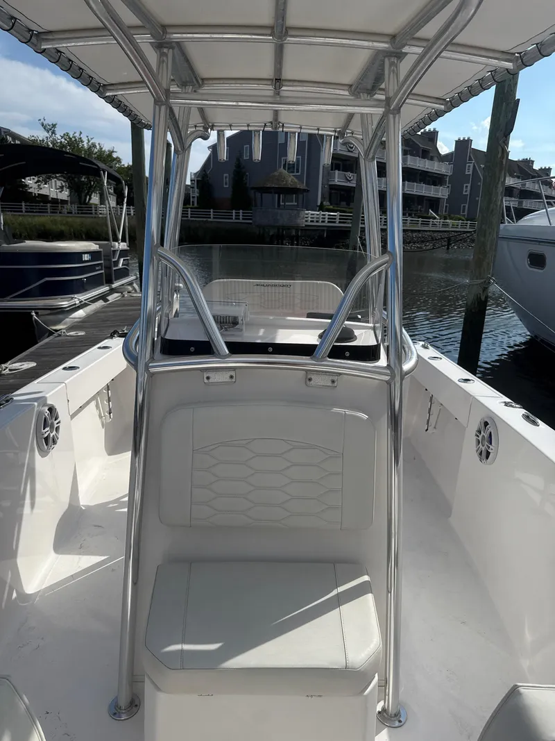 Slide: The Image of 2023 Aquasport 2200 Center Console boat docked, featuring sleek design and spacious seating. - 7