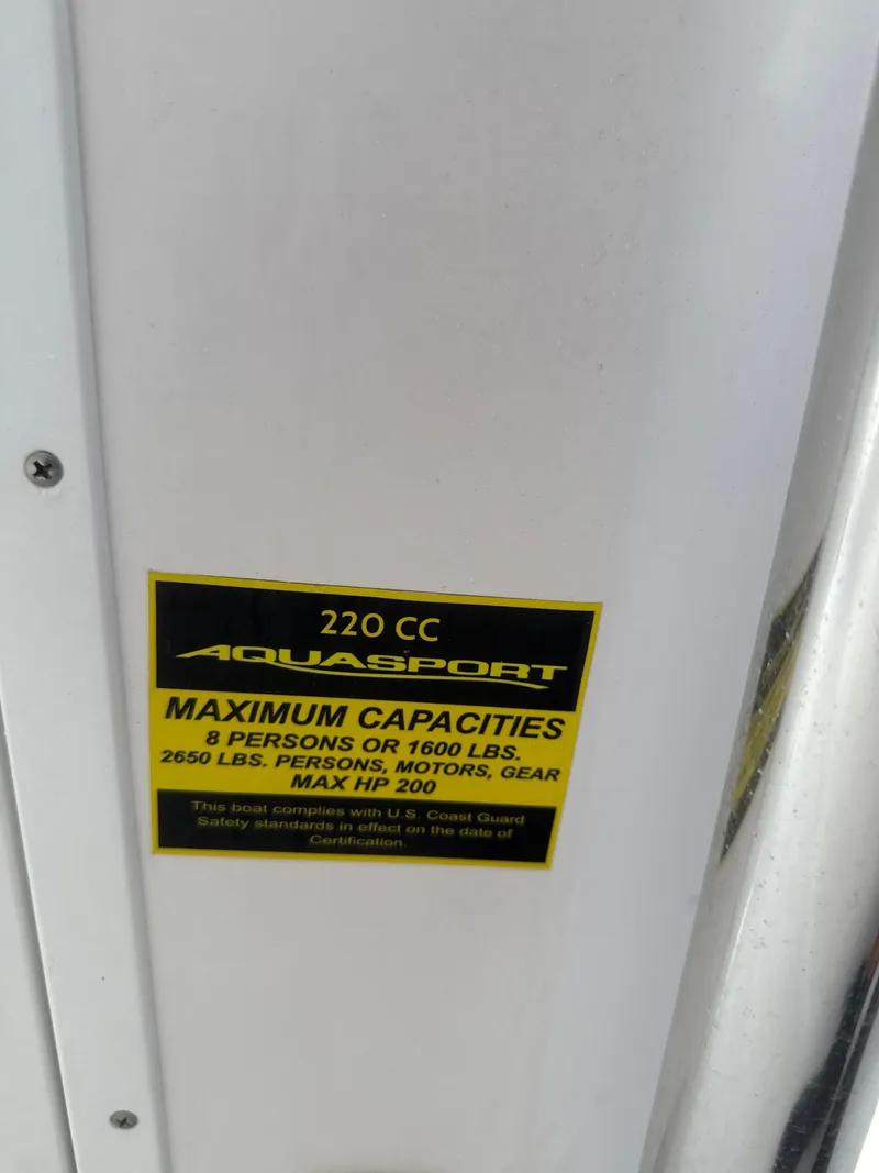 Slide: The Image of 2023 Aquasport 2200 Center Console capacity label, 8 persons or 1600 lbs, max HP 200. - 9