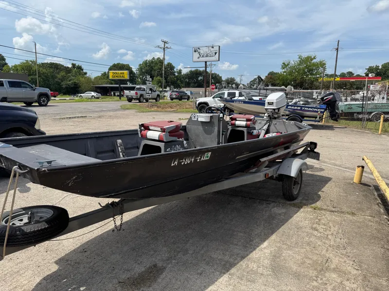 Slide: The Image of 1998 Xpress 15' boat on trailer in parking lot, sunny day. - 3