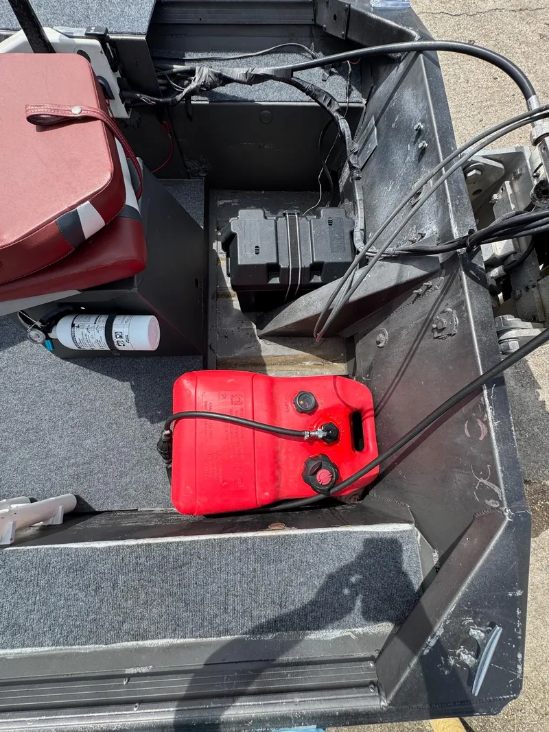 Slide: The Image of Interior of a 1998 Xpress 15' boat with red fuel tank and battery. - 5