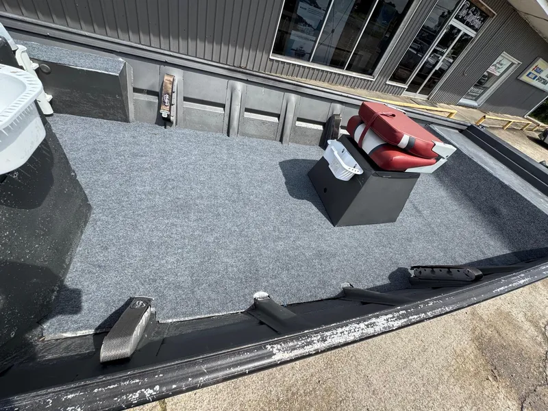 Slide: The Image of 1998 Xpress 15' boat interior with red seat and gray carpet. - 8