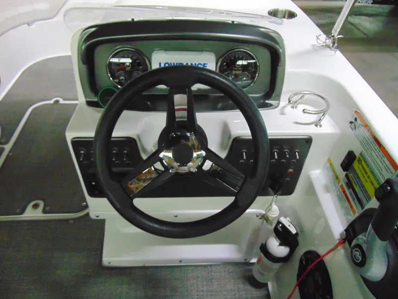Slide: The Image of 2021 Hurricane SunDeck Sport 188 IO boat dashboard with steering wheel and controls. - 8