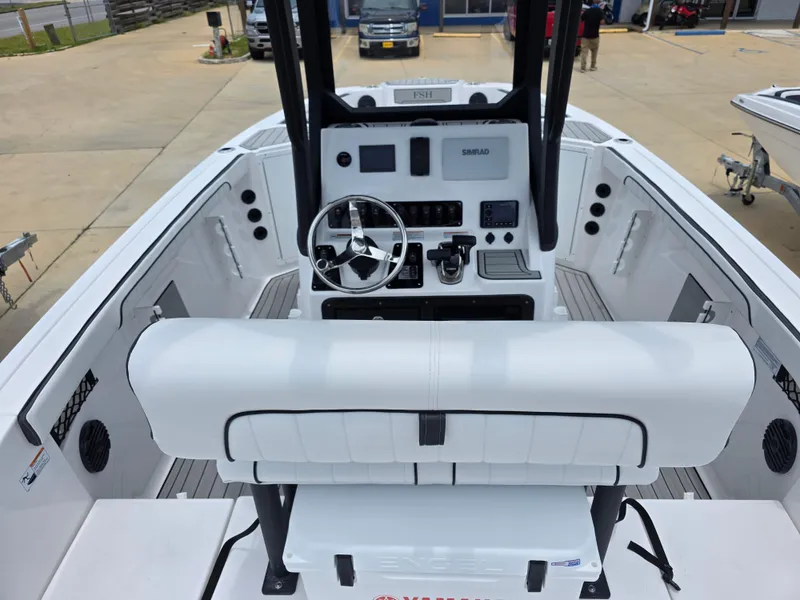 Slide: The Image of 2025 Yamaha Boats 222 FSH Sport E cockpit with steering wheel and controls. - 13