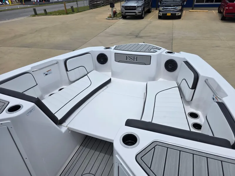 Slide: The Image of 2025 Yamaha Boats 222 FSH Sport E interior with spacious seating and cup holders. - 16