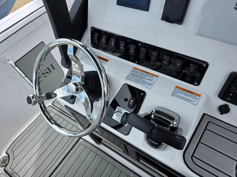 Slide: The Image of 2025 Yamaha Boats 222 FSH Sport E dashboard with steering wheel and controls. - 4