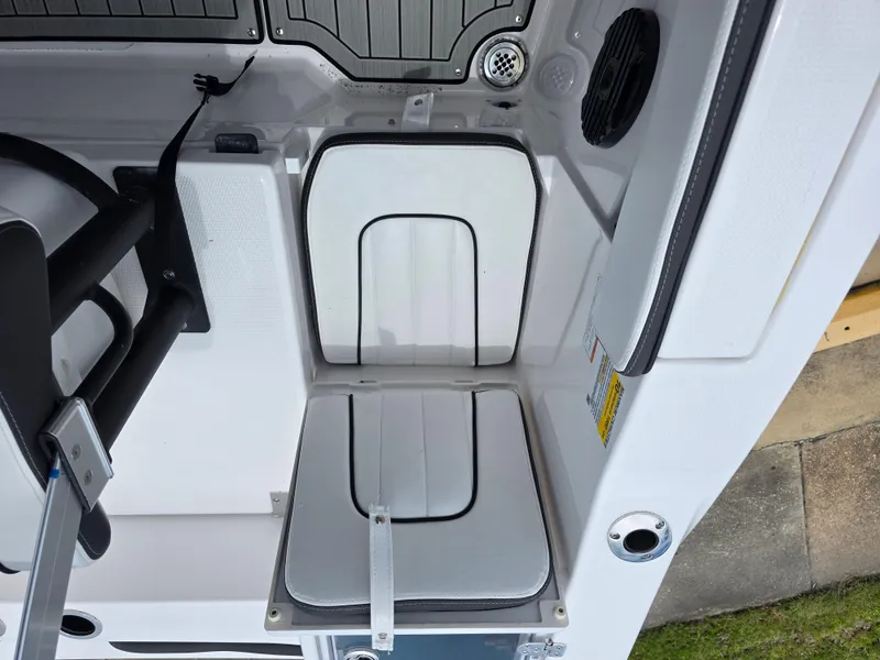 Slide: The Image of 2025 Yamaha Boats 222 FSH Sport E interior seating and storage area. - 5