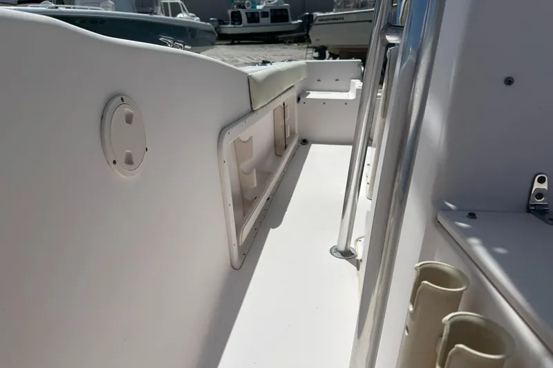 Slide: The Image of 2005 Grady-White Escape 209 boat interior, featuring seating and storage compartments. - 16