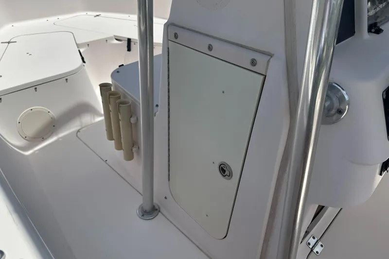 Slide: The Image of 2005 Grady-White Escape 209 boat interior with rod holders and storage compartment. - 18
