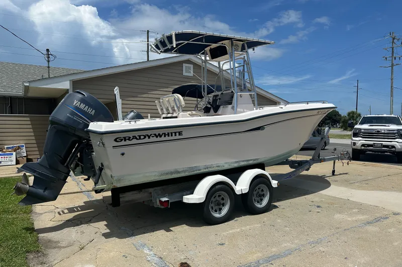 Slide: The Image of 2005 Grady-White Escape 209 boat on trailer with Yamaha engine, parked outdoors. - 2