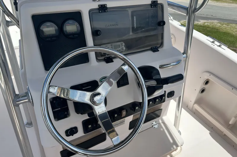 Slide: The Image of 2005 Grady-White Escape 209 boat dashboard with steering wheel and navigation instruments. - 20