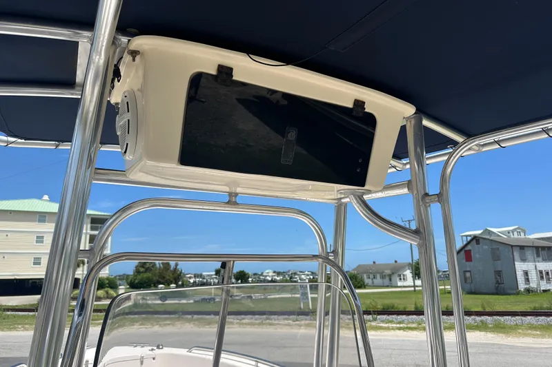 Slide: The Image of 2005 Grady-White Escape 209 boat with T-top and electronics box, parked near coastal homes. - 21